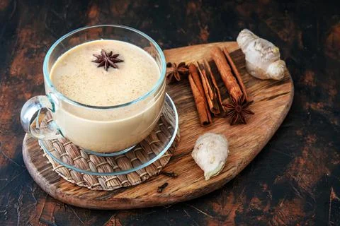 Masala tea on a clay table with spices. Top view Stock Photos