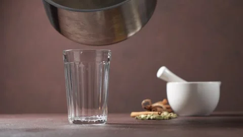 Masala tea is poured into a cut glass.Traditional Indian drink. Stock Footage 250567540