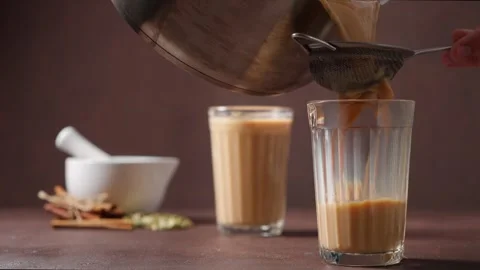 Masala tea is poured into a cut glass.Traditional Indian drink. Stock Footage 250573351