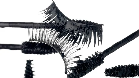 Mascara brushes with drops of liquid mascara on it and a falce lashes Stock Footage 91069782