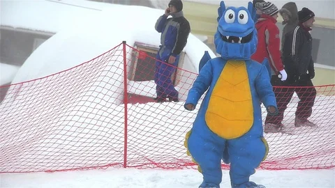 Mascot dancing on the ski slope waiting for the arrival of competitors Video stock 71756358