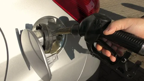 Masculine hands that feed the gas pump in the car for refueling Stock Footage 71553864