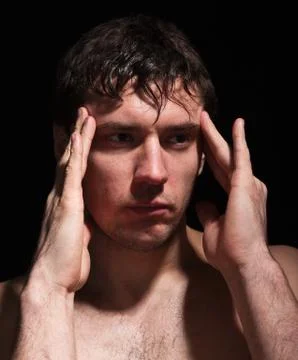Masculine problems.portrait of man on a black background.headache. Stock Photos