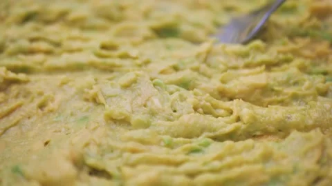 Mashed avocado in a bowl closeup. Healthy vegan vegetarian food Video stock 220115537
