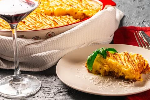 Mashed potato and minced meat casserole in a baking dish and a piece of Stock Photos