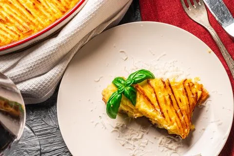 Mashed potato and minced meat casserole in a baking dish and a piece of Stock Photos