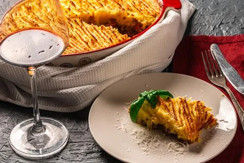 Mashed potato and minced meat casserole in a baking dish and a piece of Stock Photos