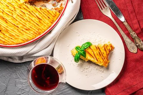 Mashed potato and minced meat casserole in a baking dish and a piece of Stock Photos
