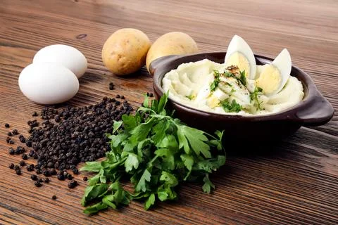 Mashed potatoes with boiled eggs coriander and black pepper served in dish .. Stock Photos
