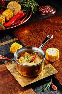 Mashed potatoes with cheddar cheese, served in a saucepan on a copper plate Stock Photos