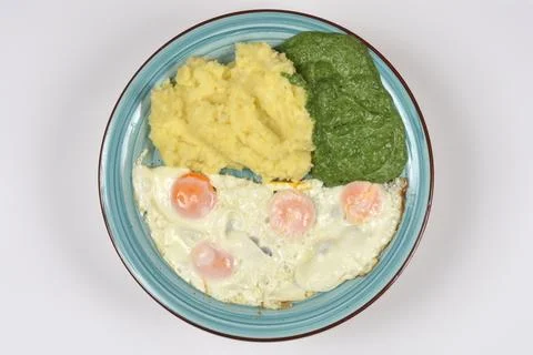 Mashed Potatoes with Creamed Spinach and Fried Eggs Stock Photos