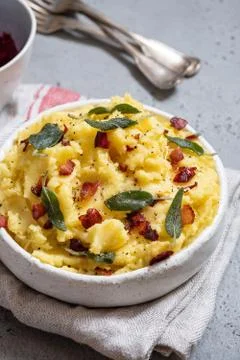 Mashed potatoes with crispy bacon and sage Stock Photos