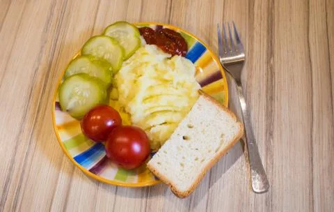 Mashed potatoes with cucumber on the plate Stock Photos