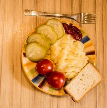 Mashed potatoes with cucumber on the plate Stock Photos