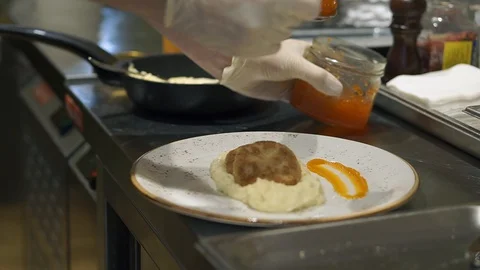 Mashed potatoes with cutlet and red caviar. Cooking chef in the restaurant Stock Footage 127599594