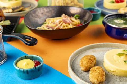 Mashed potatoes with cutlets and sauce on a background of spaghetti and bro.. Stock Photos