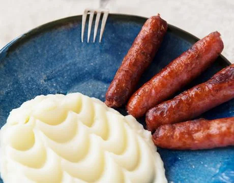 Mashed potatoes with fried sausage Stock Photos