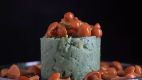 Mashed potatoes with green spirulina and honey mushrooms in a plate, rotate Stock Footage 146018666