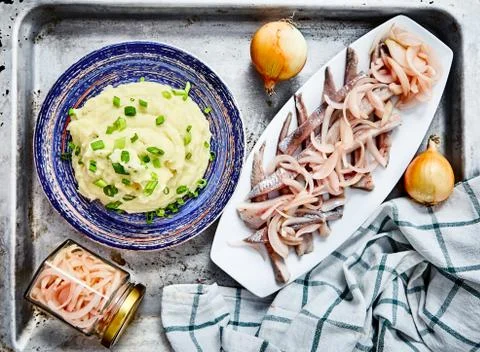 Mashed potatoes with herring and pickled onions Stock Photos