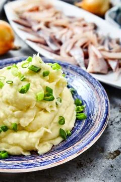 Mashed potatoes with herring and pickled onions Stock Photos