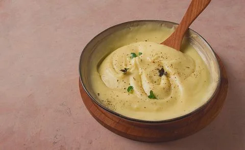 Mashed potatoes, with micro greenery and spices, homemade, on a beige table.. Stock Photos