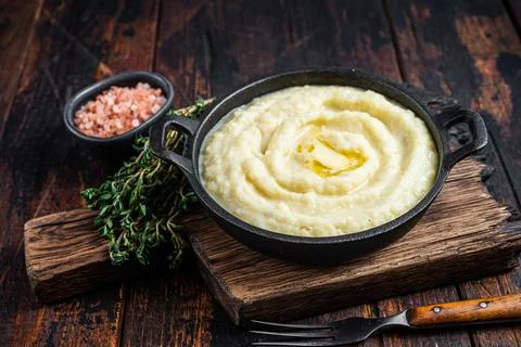 Mashed potatoes in a pan on wooden rustic table. Wooden background. Top view Stock Photos