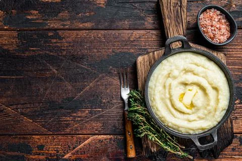 Mashed potatoes in a pan on wooden rustic table. Wooden background. Top view Stock Photos