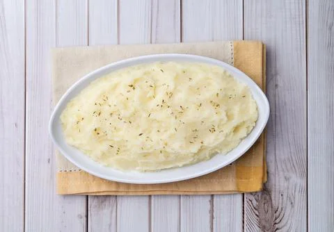 Mashed potatoes in a plate over white wooden table Stock Photos