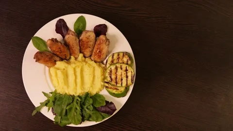 Mashed potatoes salad, fried chicken and zucchini on table Rucola featured in Stock Footage 264464399