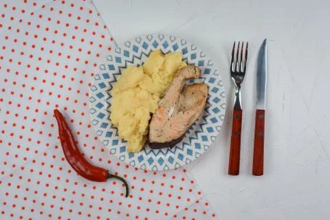 Mashed potatoes with salmon steak served on the plate on the white background Stock Photos
