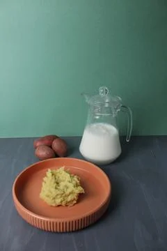 Mashed potatoes side dish of potatoes with milk in a jug on a gray backgrou.. Stock Photos