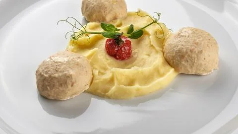 Mashed potatoes with steam meatballs on a white plate. Close-up Stock Photos