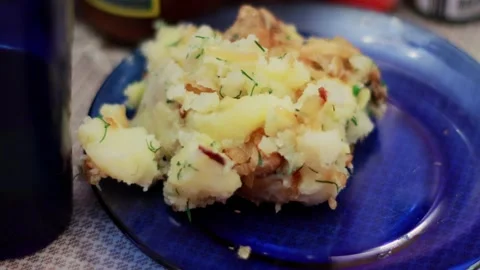 Mashed potatoes with stewed meat in a blue plate on the table, close-up Stock Footage 264771587