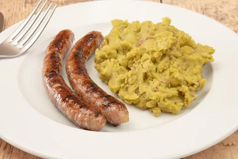Mashed split peas on a plate with fresh sausages Stock Photos