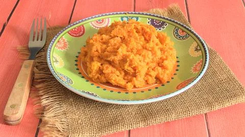 Mashed sweet potatoes on a plate Stock Photos