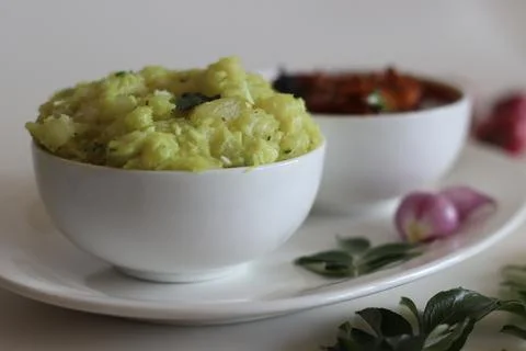 Mashed tapioca served with pomfret fish curry. Boiled and strained tapioca pi Stock Photos