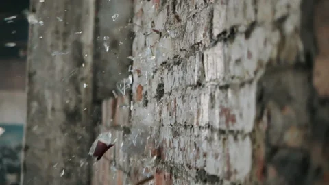 Mashing empty glass bottle on brick wall shooting with high speed camera Stock Footage 147351868
