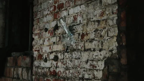 Mashing empty glass bottle on brick wall shooting with high speed camera Video stock 147352842