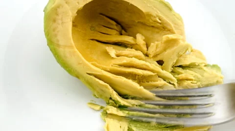 Mashing half avocado into paste with fork Stock Footage 46955455