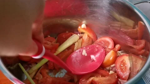 Mashing Tomatoes Using a Ladle Stock Footage 159319937
