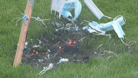 Mask burning at an Unmask Minnesota protest Video stock 140287053