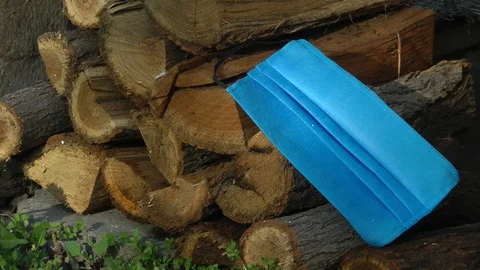 Mask from coronavirus on a stack of firewood Vídeo Stock 129053879