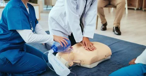 Mask, hands or nurses learning cpr on mannequin for first aid, cardiac arrest or Stockfoto's