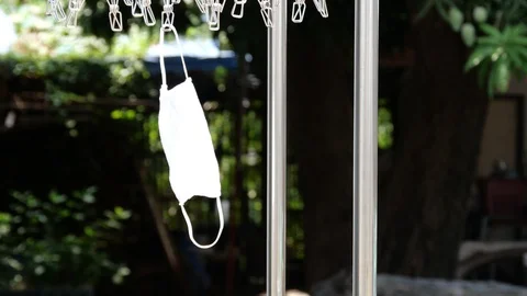 A mask hanging on a  stainless clothespin. Stock Footage 130170859