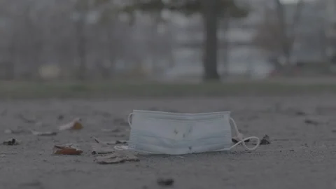 Mask laying on the ground, get trampled - Coronavirus Covid-19 Epidemic | LOG Stock Footage 165659853
