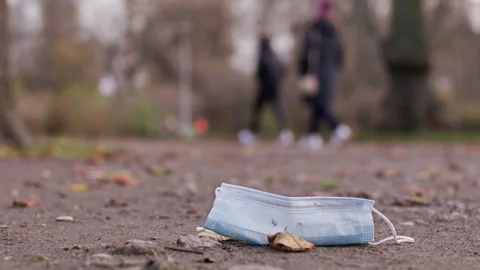 Mask laying on the ground, get trampled - Coronavirus Covid-19 Epidemic Stock Footage 165661163