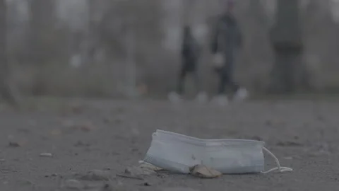 Mask laying on the ground, get trampled - Coronavirus Covid-19 Epidemic Stock Footage 165661213