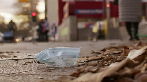Mask laying on ground, get trampled, city - Coronavirus Covid-19 Epidemic Stock Footage 165682266