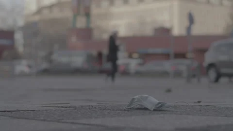 Mask laying on ground, get trampled, city - Coronavirus Covid-19 Epidemic | LOG Stock Footage 166040842