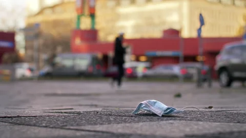 Mask laying on ground, get trampled, city - Coronavirus Covid-19 Epidemic Stock Footage 166040887